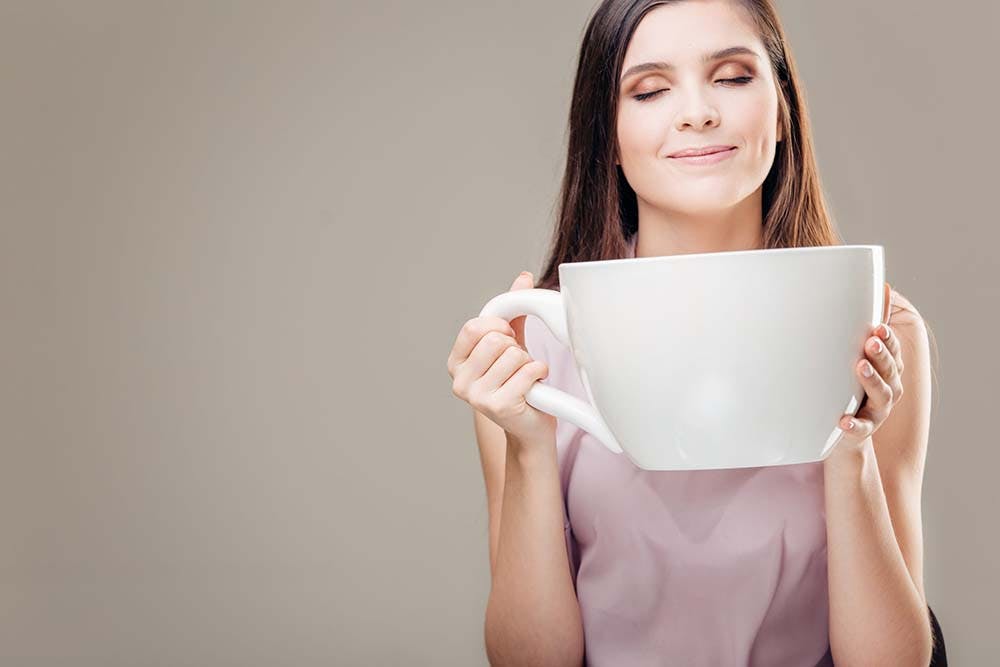 Female drinking big cup of coffee
